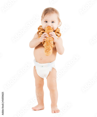 Photo: cute todler eating long bread cute todler eating long bread