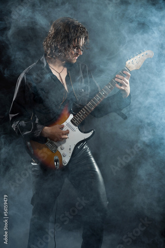 Photo: Psychedelic rock guitarist with long brown hair and beard. Dress Psychedelic rock guitarist with long brown hair and beard. Dress