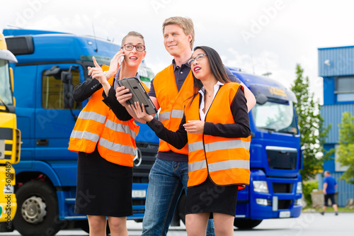 Photo: Forwarder in front of trucks on a depot Forwarder in front of trucks on a depot