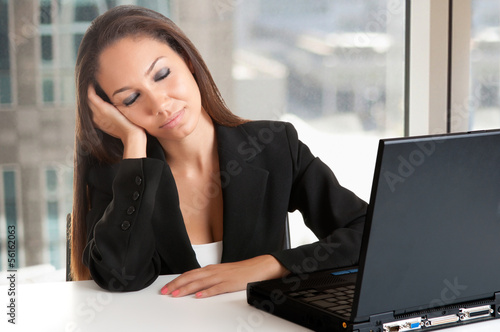 Photo: Businesswoman Sitting at Her Desk Sleeping Businesswoman Sitting at Her Desk Sleeping