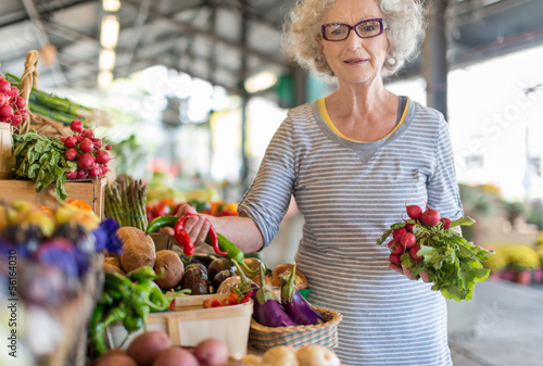 Photo: senior woman shopping at the farmer's market senior woman shopping at the farmer's market