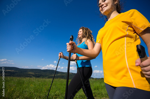 Photo: Nordic walking - active people outdoor Nordic walking - active people outdoor