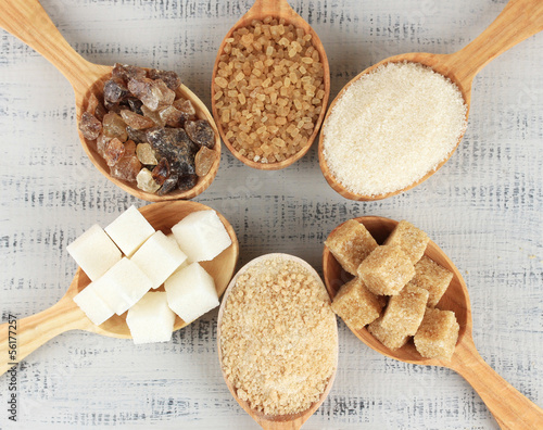 Photo: Different types of sugar in spoons on table close-up Different types of sugar in spoons on table close-up