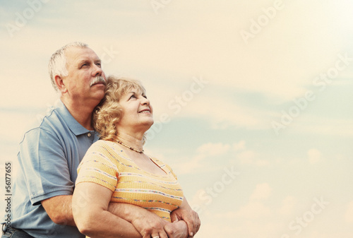 Photo: Old people over sky background Old people over sky background