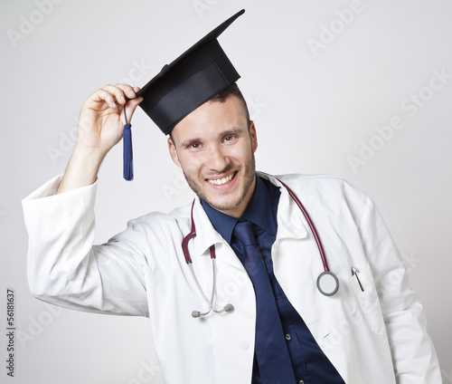 Photo: young doctor smiling with mortarboard young doctor smiling with mortarboard