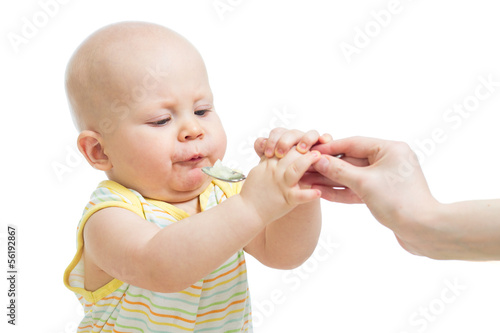 Photo: baby boy eating with a spoon baby boy eating with a spoon