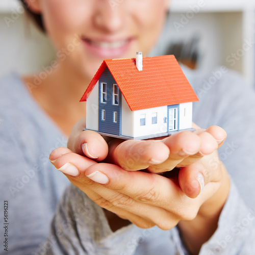 Photo: Hands holding a little house Hands holding a little house