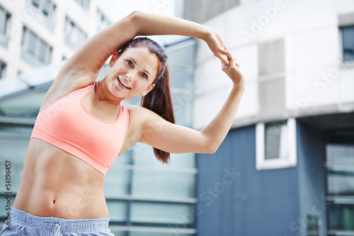 Photo: Athletic woman exercising in the city Athletic woman exercising in the city