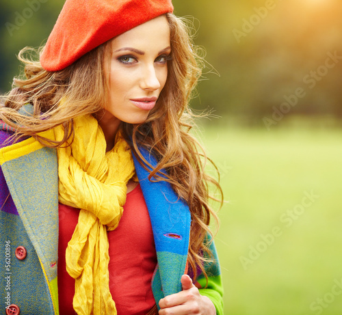 Photo: Fashion woman walking in autumn park Fashion woman walking in autumn park