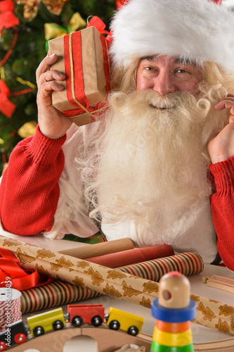 Photo: Santa Claus in his workshop making new toys Santa Claus in his workshop making new toys