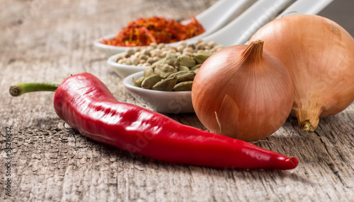 Photo: Close up photo of spices with chili pepper and onion Close up photo of spices with chili pepper and onion