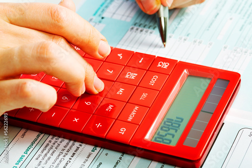 Photo: Hands with calculator. Hands with calculator.