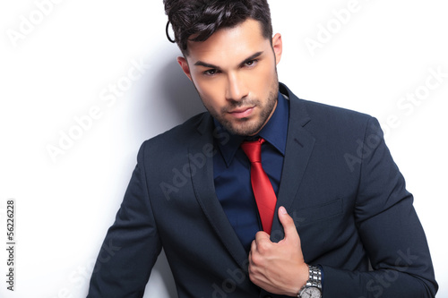Photo: closeup of business man with hand on lapel closeup of business man with hand on lapel