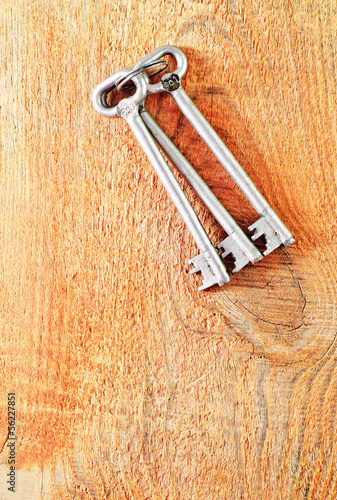 Photo: key on wooden background key on wooden background
