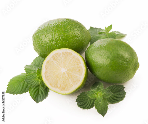 Photo: Fresh limes, mint leaves isolated on white Fresh limes, mint leaves isolated on white