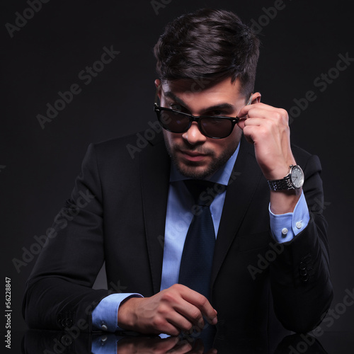 Photo: young business man looks over his sunglasses young business man looks over his sunglasses