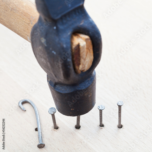 Photo: hammer nails into wooden plank hammer nails into wooden plank