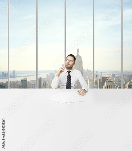 Photo: man sitting in office man sitting in office