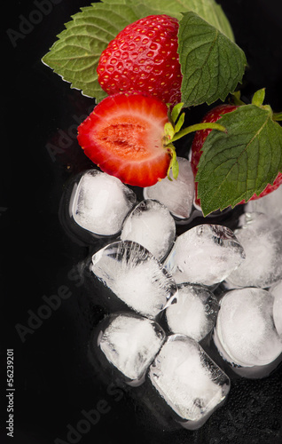 Photo: ice cubes, mint leaf, fresh strawberry on black ice cubes, mint leaf, fresh strawberry on black