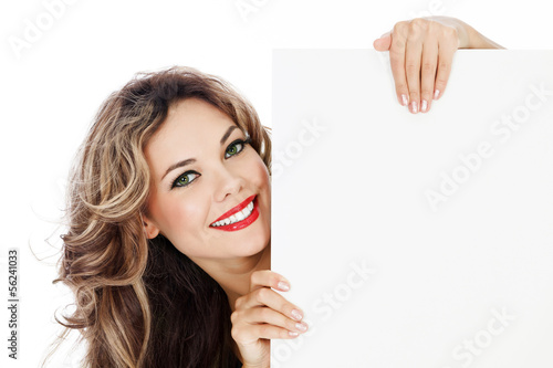 Photo: Young smiling woman shows blank card. Young smiling woman shows blank card.