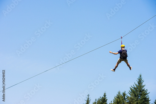 Photo: Young Man Riding On Zip Line Young Man Riding On Zip Line