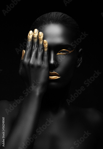  dark-skinned woman with golden make-up.