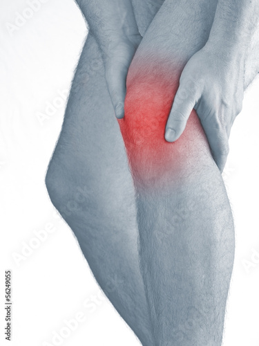 Photo: Acute pain in a man knee. Male holding hand to spot of knee-ach Acute pain in a man knee. Male holding hand to spot of knee-ach