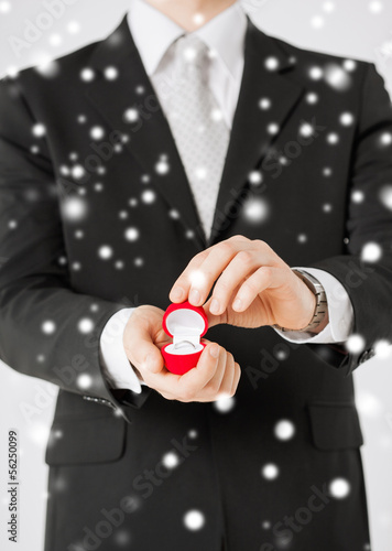 Photo: man with gift box and wedding ring man with gift box and wedding ring