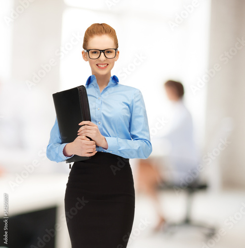 Photo: smiling woman with folder smiling woman with folder