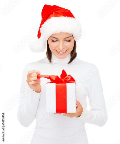 Photo: smiling woman in santa helper hat with gift box smiling woman in santa helper hat with gift box