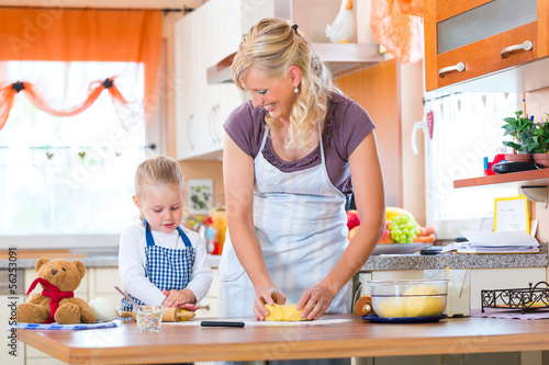 Photo: Mother and daughter baking cookies together Mother and daughter baking cookies together