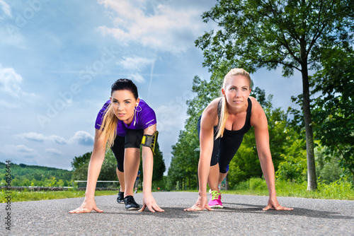 Photo: Sports outdoor - young women doing fitness in park Sports outdoor - young women doing fitness in park
