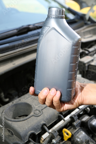 Photo: Auto mechanic hand holding motor oil Auto mechanic hand holding motor oil