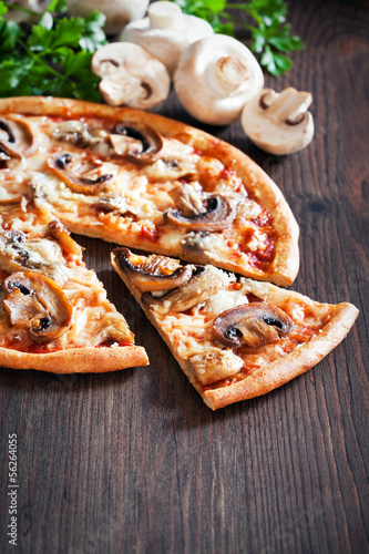Photo: Vegetarian pizza with mushrooms, selective focus Vegetarian pizza with mushrooms, selective focus