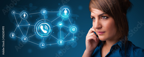Photo: Pretty girl making phone call with social network icons Pretty girl making phone call with social network icons
