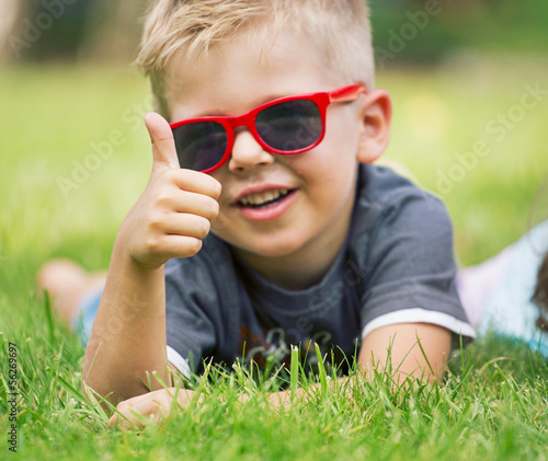 Photo: Portrait of happy boy showing thumbs up gesture Portrait of happy boy showing thumbs up gesture