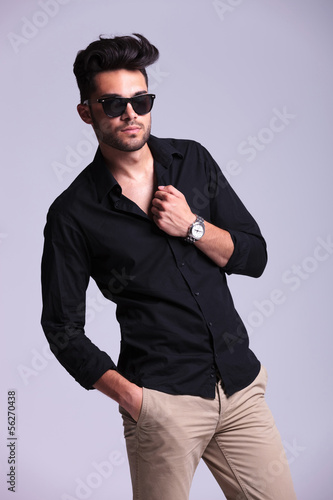 Photo: young fashion man with a hand on his collar young fashion man with a hand on his collar