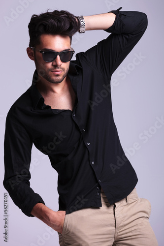 Photo: young fashion man adjusting hair young fashion man adjusting hair
