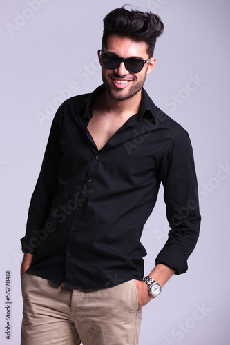 Photo: young fashion man smiles with hand in pocket young fashion man smiles with hand in pocket