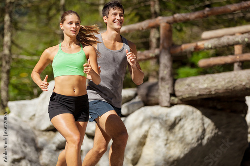 Photo: Young sporty couple is doing running exercises Young sporty couple is doing running exercises