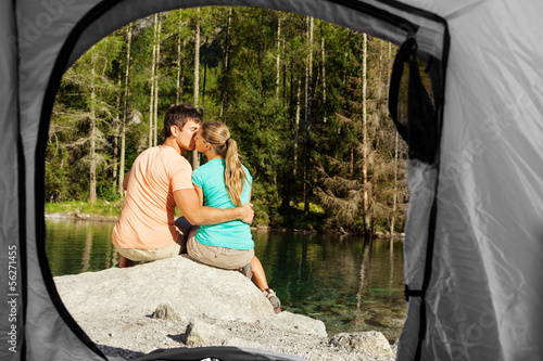 Photo: view of a couple that camps from the inside of a tent view of a couple that camps from the inside of a tent