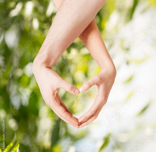 Photo: woman and man hands showing heart shape woman and man hands showing heart shape