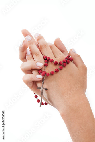 Photo: Praying with rosary, isolated Praying with rosary, isolated