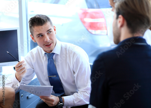 Photo: Image of business partners discussing documents and ideas Image of business partners discussing documents and ideas