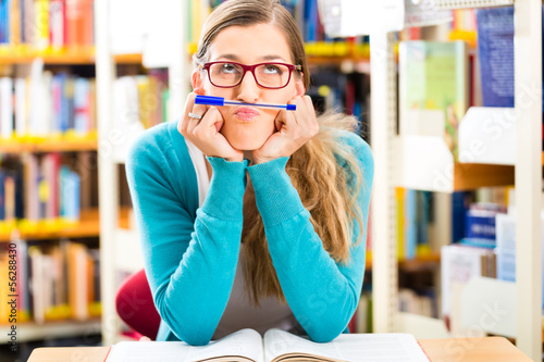 Photo: Student with books learning in library Student with books learning in library