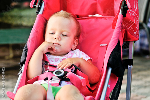 Photo: cute baby girl in stroller cute baby girl in stroller