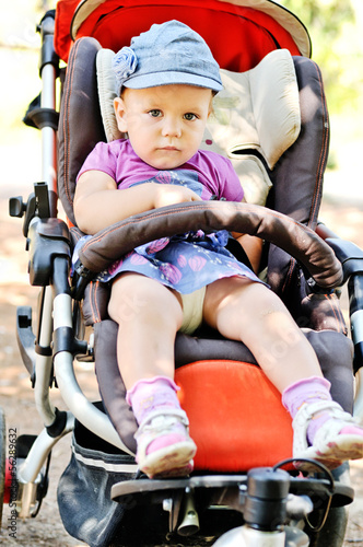 Photo: cute baby girl in stroller cute baby girl in stroller