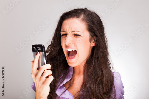 Photo: Woman shouting to a cell phone Woman shouting to a cell phone