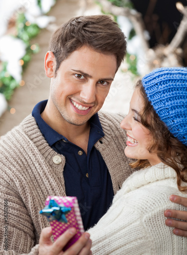 Photo: Happy Man Embracing Woman In Christmas Store Happy Man Embracing Woman In Christmas Store