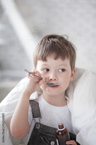 Photo: boy drinking cough syrup boy drinking cough syrup